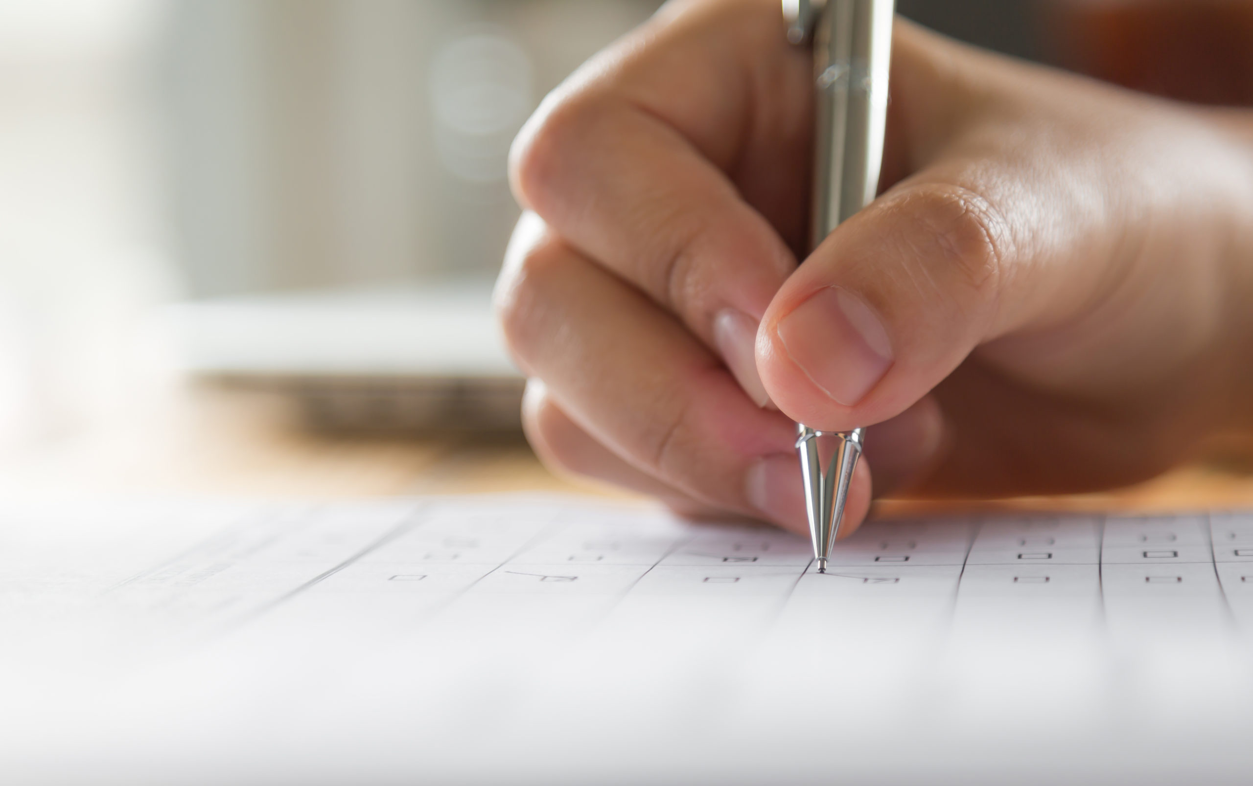 Hand With Pen Over Application Form - Contabilidade em Santa Catarina | Amaral Contabilidade